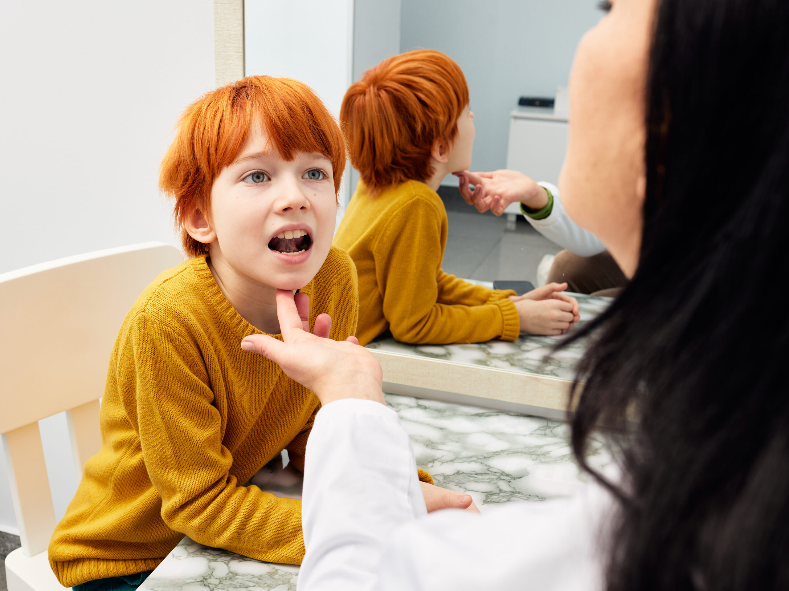 Male child in session with a speech therapist