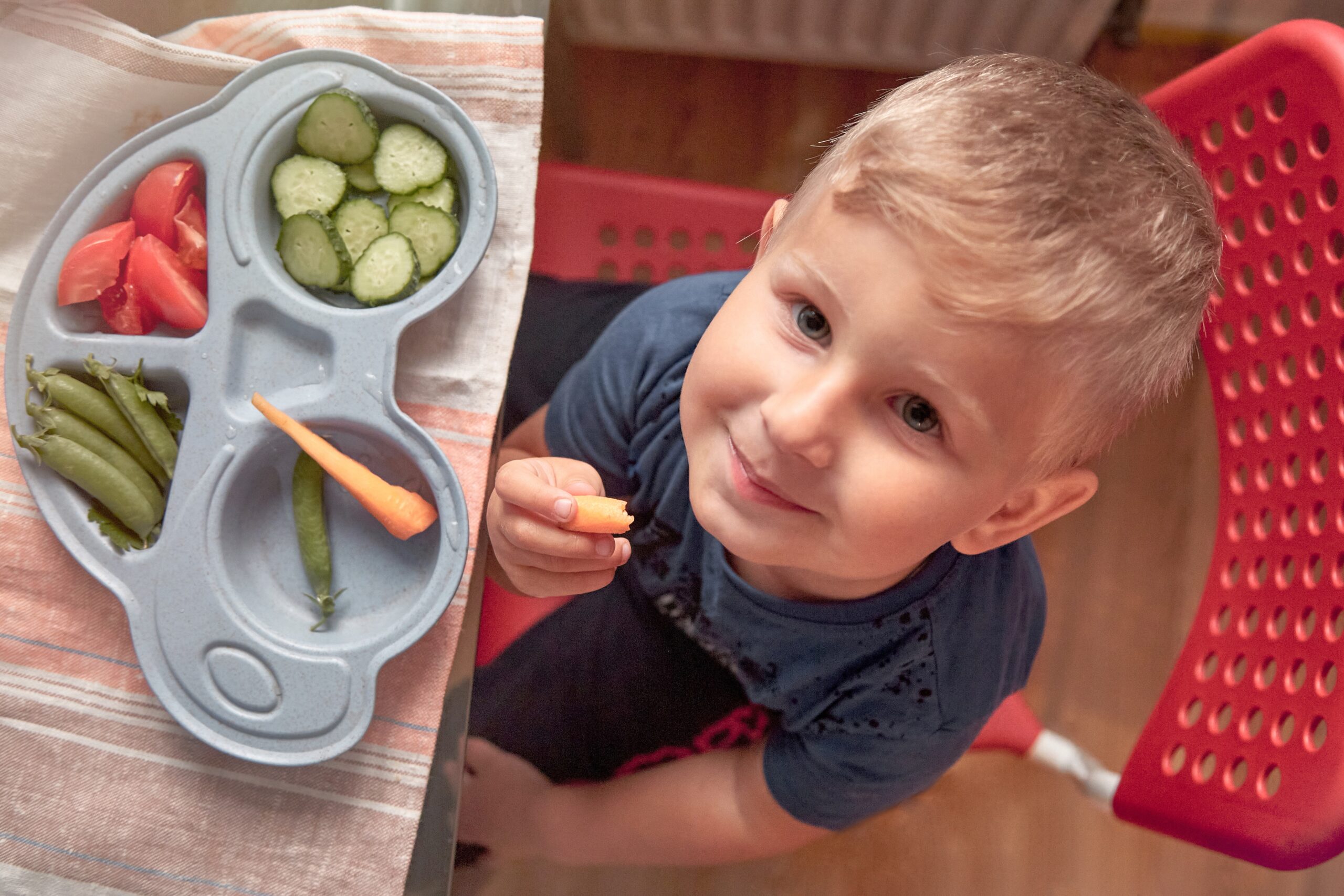 smiling-happy-child-eating-fresh-healthy-vegetable-2025-03-08-04-50-06-utc