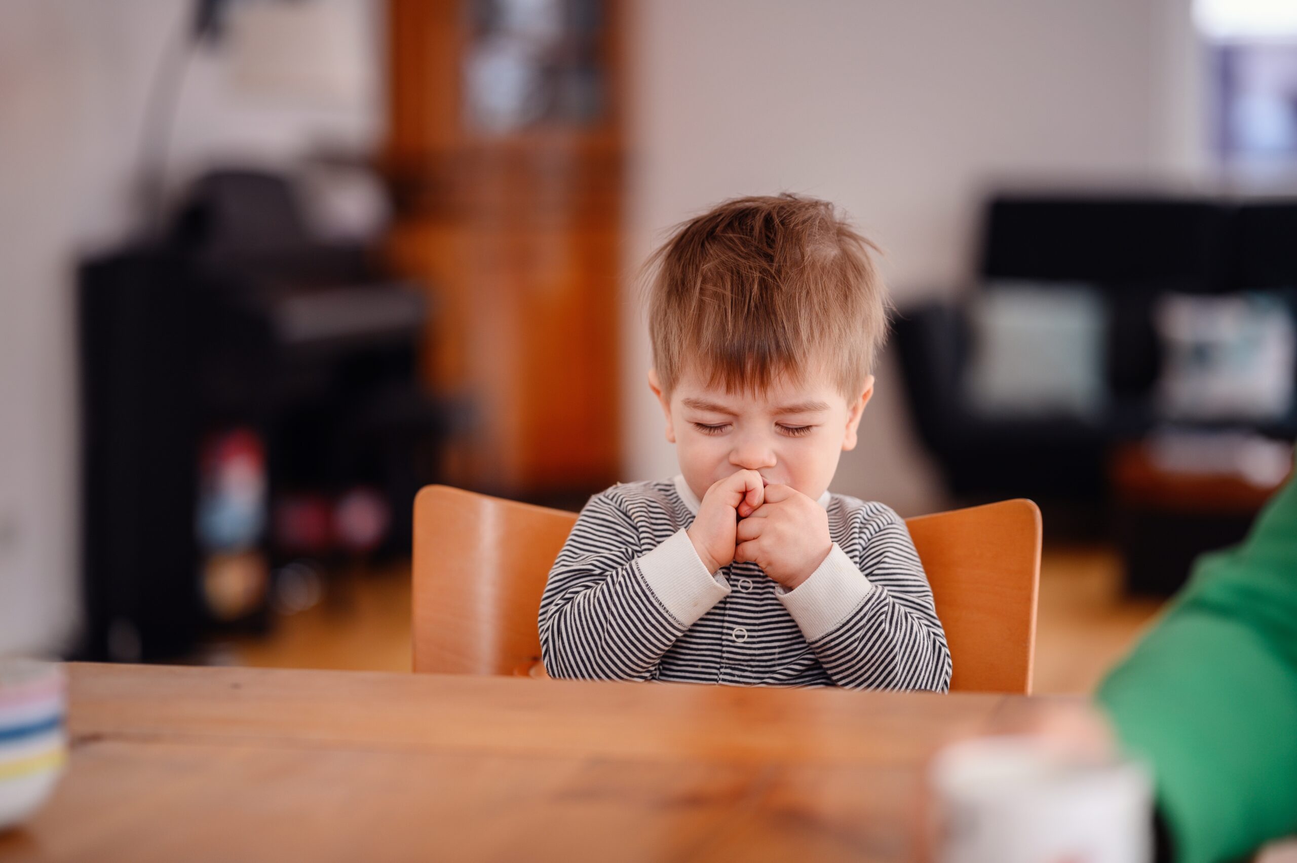 little-toddler-boy-sitting-at-wooden-table-sadly-l-2025-01-07-06-53-10-utc